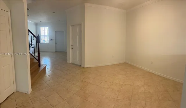 a view of a hallway with a refrigerator