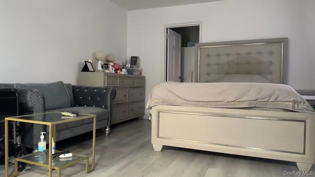 a room with a bed and a dresser