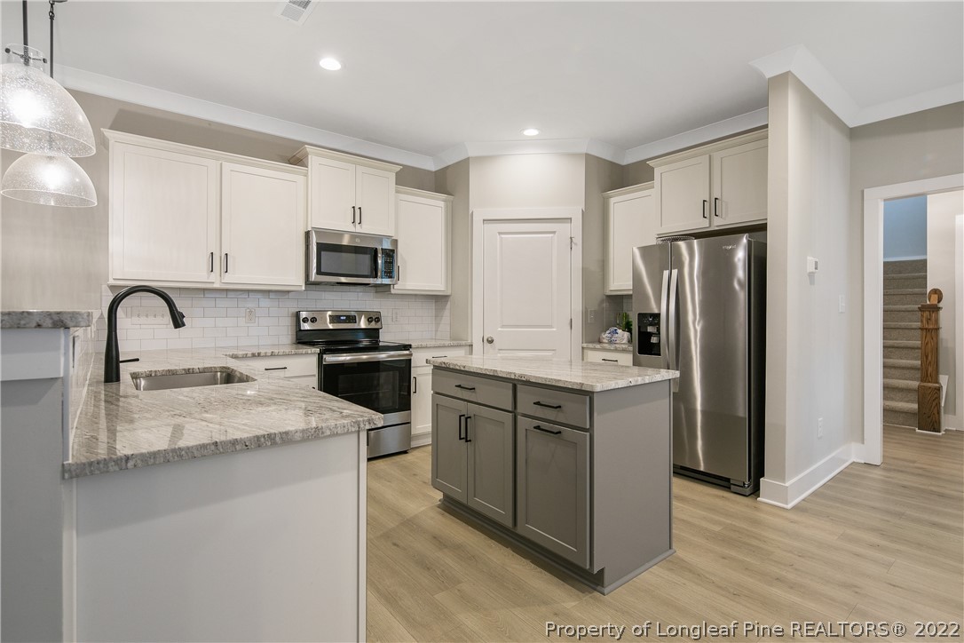 36 Spruce Hollow Circle Spring Lake, NC 28390 - Photo 13 of 49 a kitchen with granite countertop a refrigerator and a sink