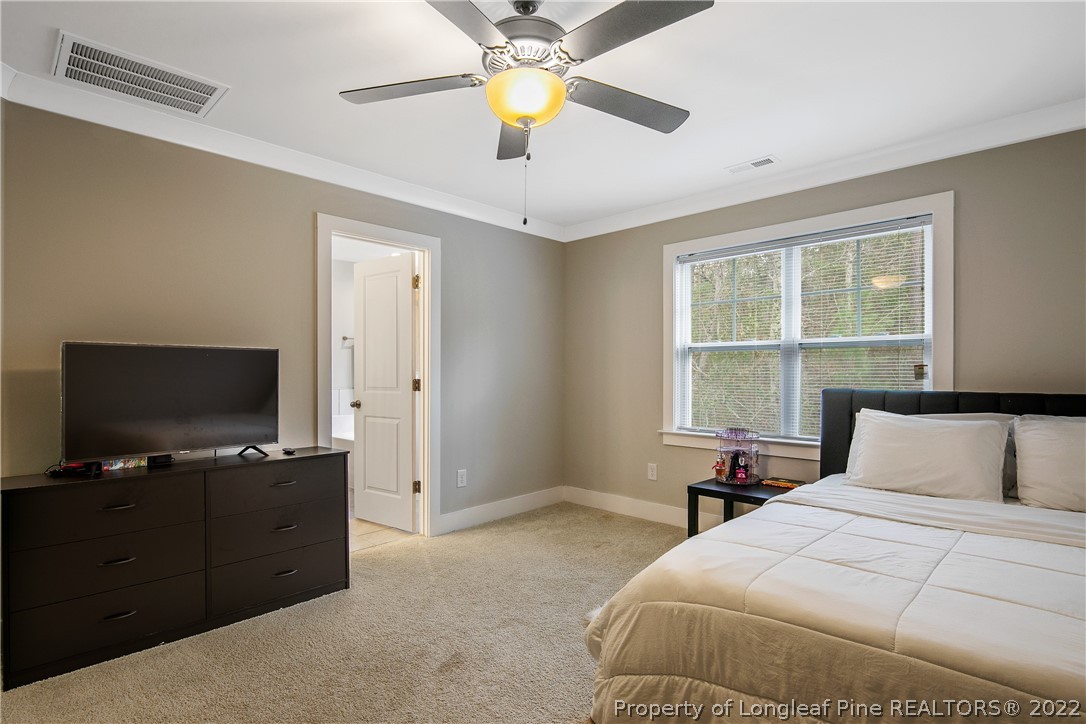 36 Spruce Hollow Circle Spring Lake, NC 28390 - Photo 26 of 49 a bedroom with a bed and a flat tv screen on the dresser