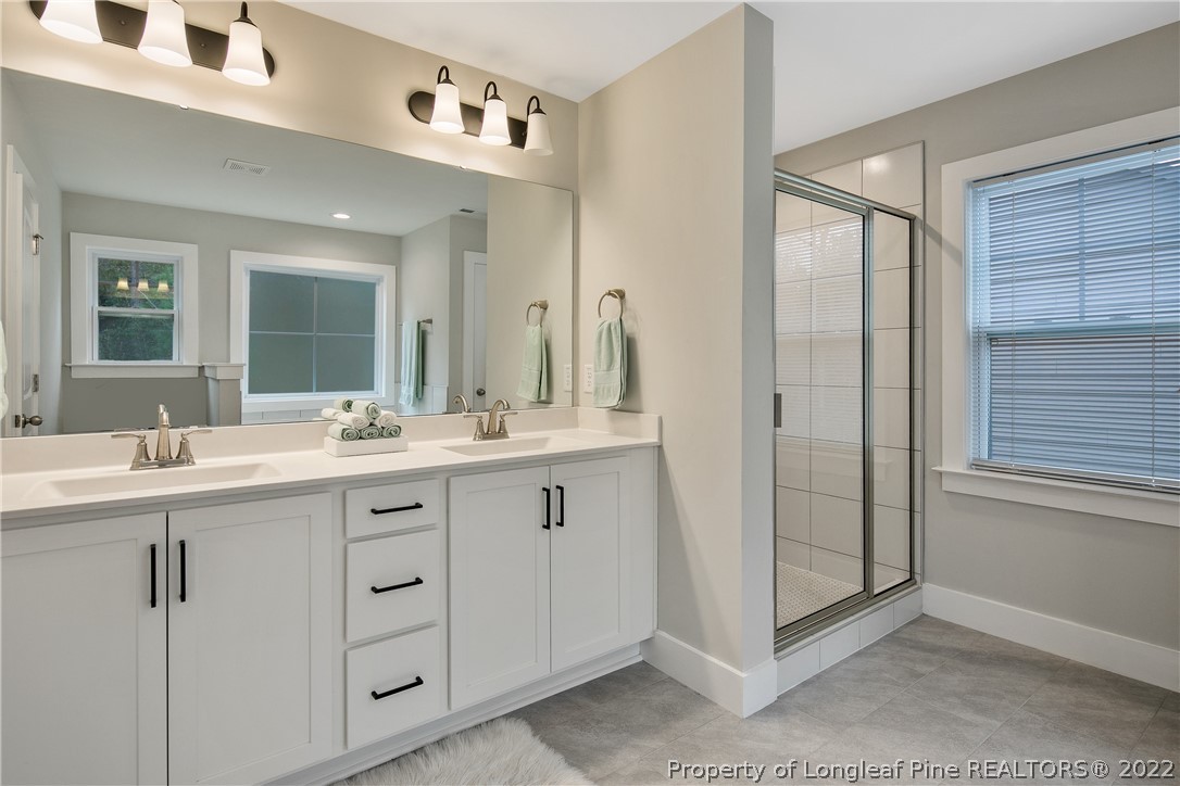 36 Spruce Hollow Circle Spring Lake, NC 28390 - Photo 28 of 49 a bathroom with a double vanity sink and mirror