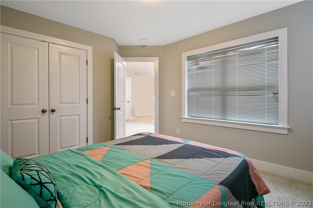 36 Spruce Hollow Circle Spring Lake, NC 28390 - Photo 35 of 49 a bedroom with a bed and a window