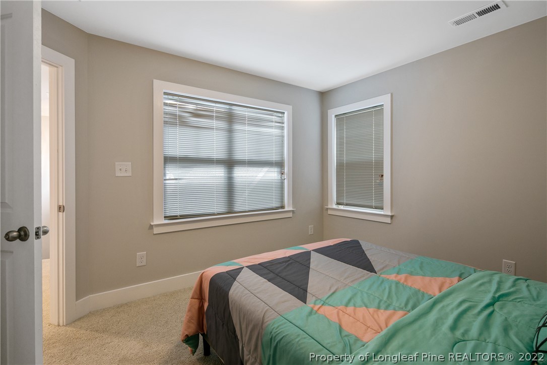 36 Spruce Hollow Circle Spring Lake, NC 28390 - Photo 36 of 49 a bed sitting in a bedroom next to a window