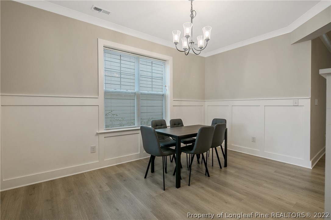 36 Spruce Hollow Circle Spring Lake, NC 28390 - Photo 8 of 49 a view of a dining room with furniture and wooden floor