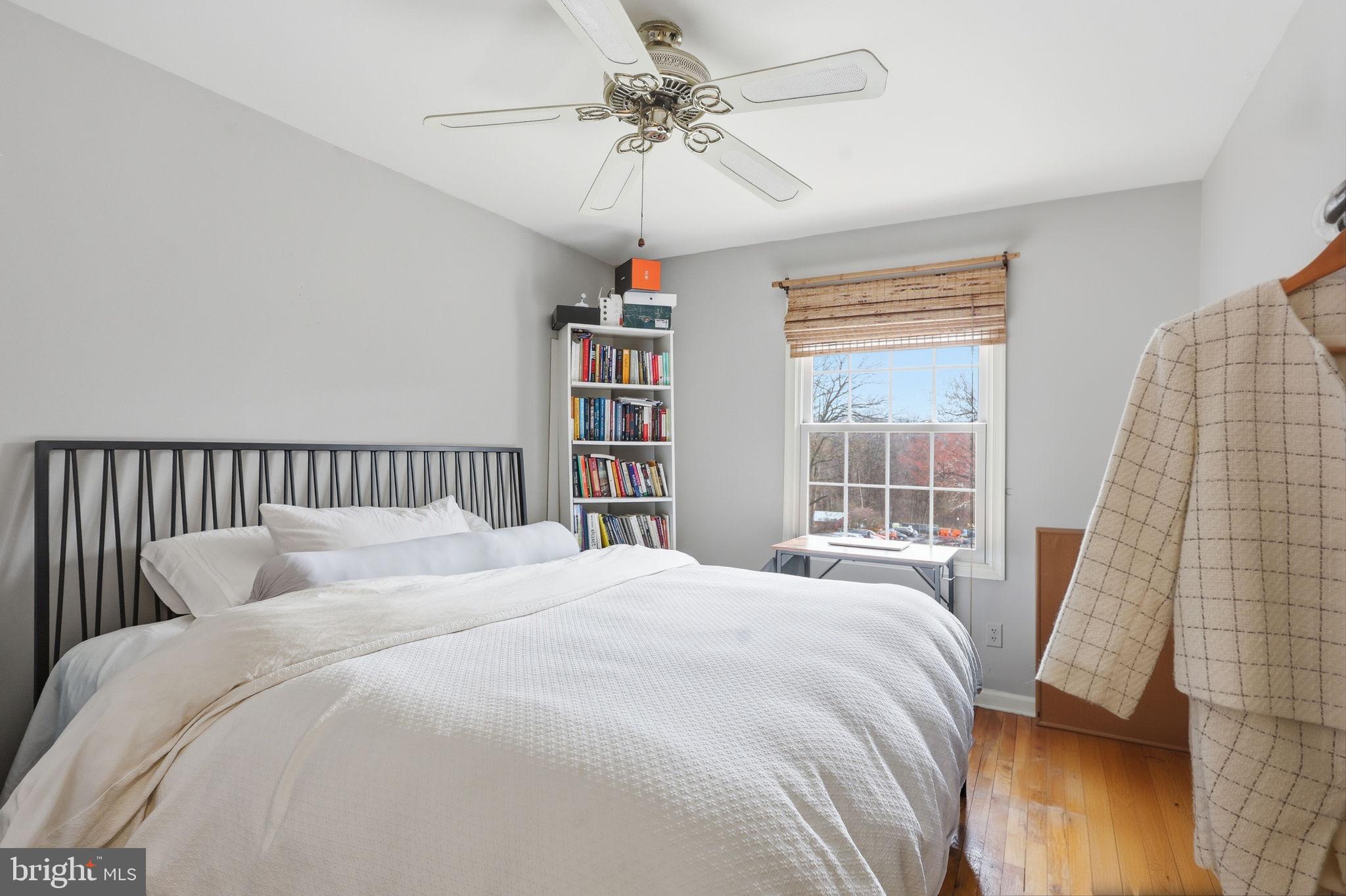 8222 Carrleigh Parkway, Unit 12 Springfield, VA 22152 - Photo 15 of 22 a bedroom with a large bed and a chandelier