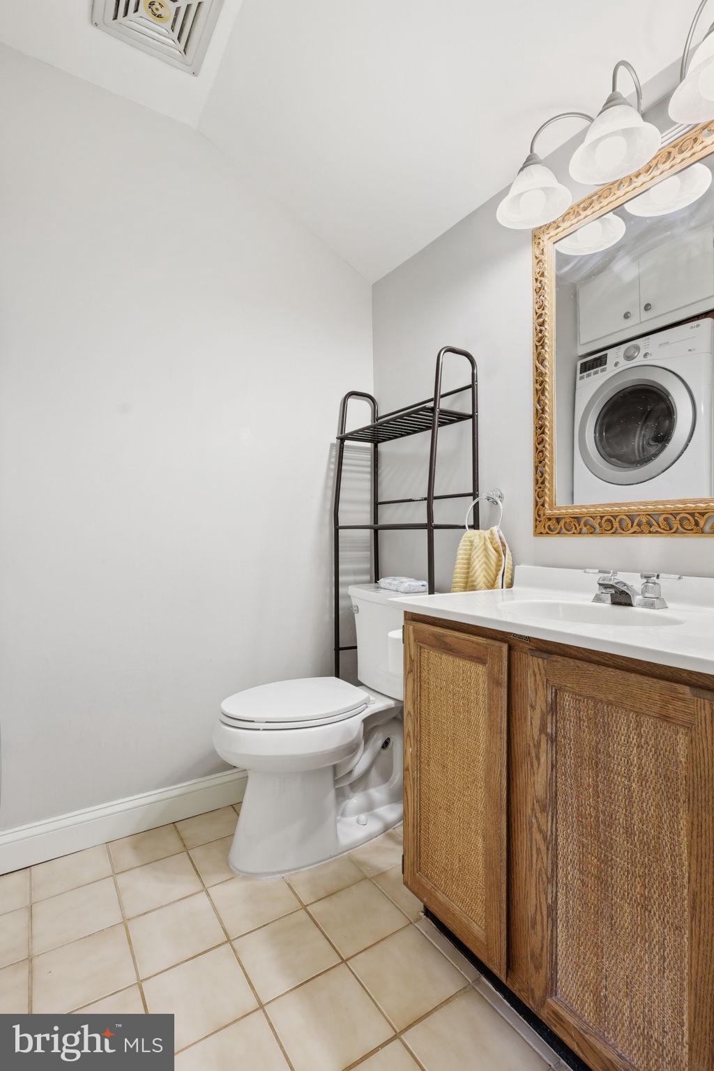 8222 Carrleigh Parkway, Unit 12 Springfield, VA 22152 - Photo 16 of 22 a bathroom with a toilet a sink and mirror