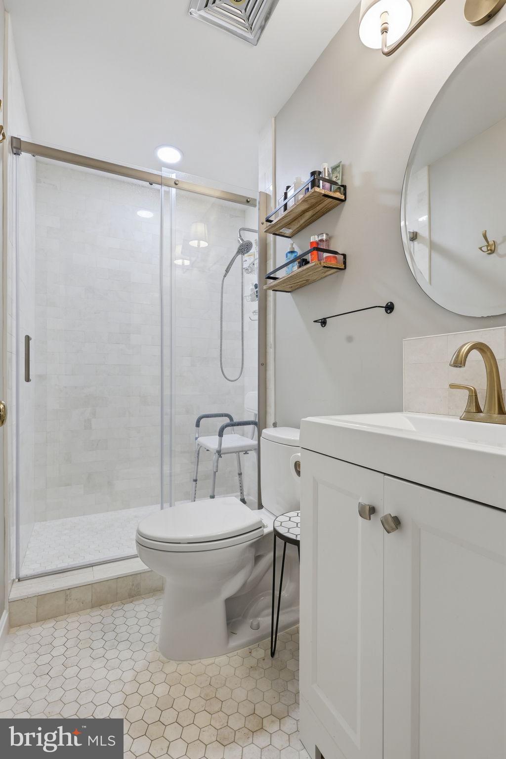 8222 Carrleigh Parkway, Unit 12 Springfield, VA 22152 - Photo 17 of 22 a bathroom with a sink toilet and shower