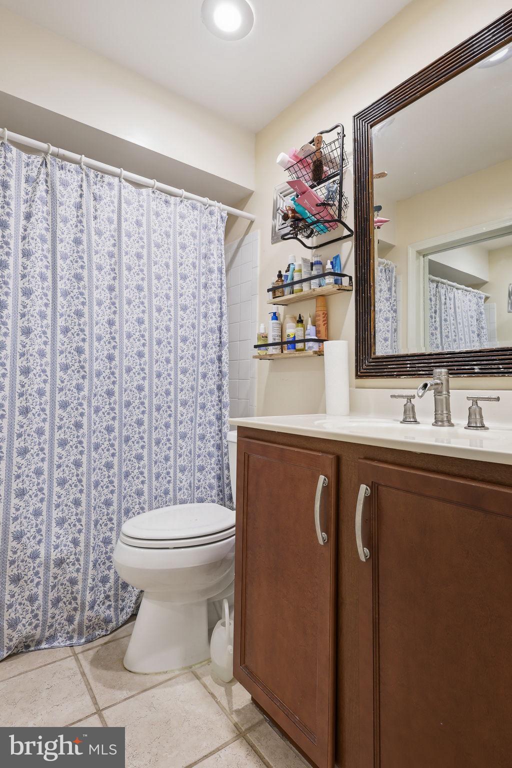 8222 Carrleigh Parkway, Unit 12 Springfield, VA 22152 - Photo 18 of 22 a bathroom with a sink a toilet and a mirror