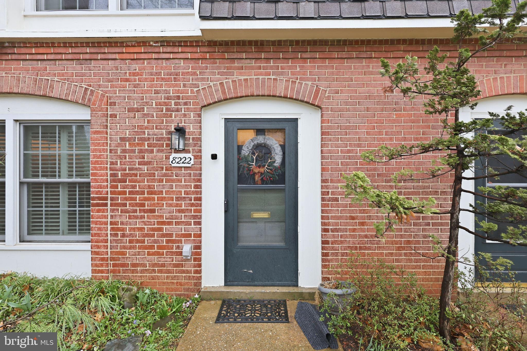 8222 Carrleigh Parkway, Unit 12 Springfield, VA 22152 - Photo 2 of 22 a front view of a house with a garden