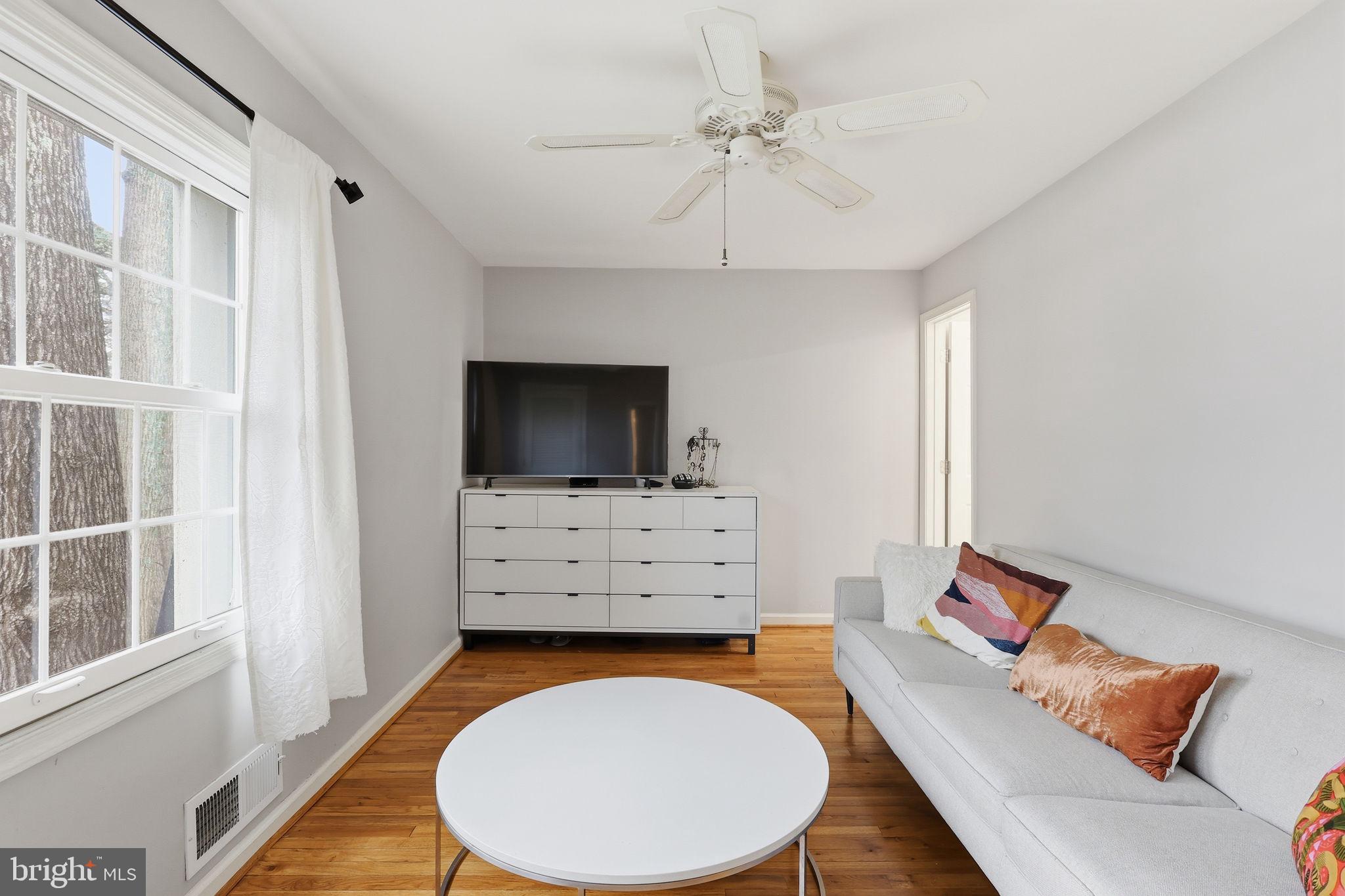 8222 Carrleigh Parkway, Unit 12 Springfield, VA 22152 - Photo 6 of 22 a living room with furniture and a flat screen tv