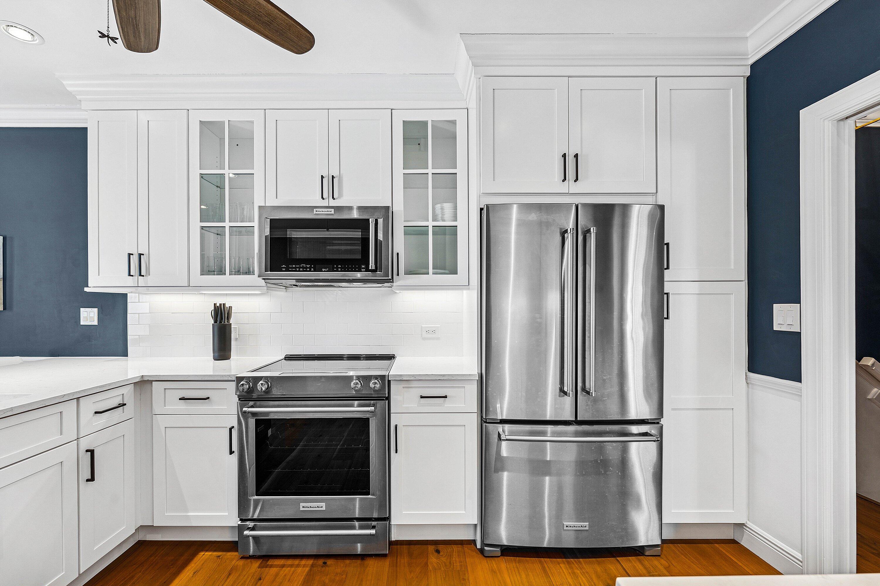 5900 Old Ocean Boulevard, Unit C4 Ocean Ridge, FL 33435 - Photo 11 of 25 a kitchen with wooden cabinets and stainless steel appliances