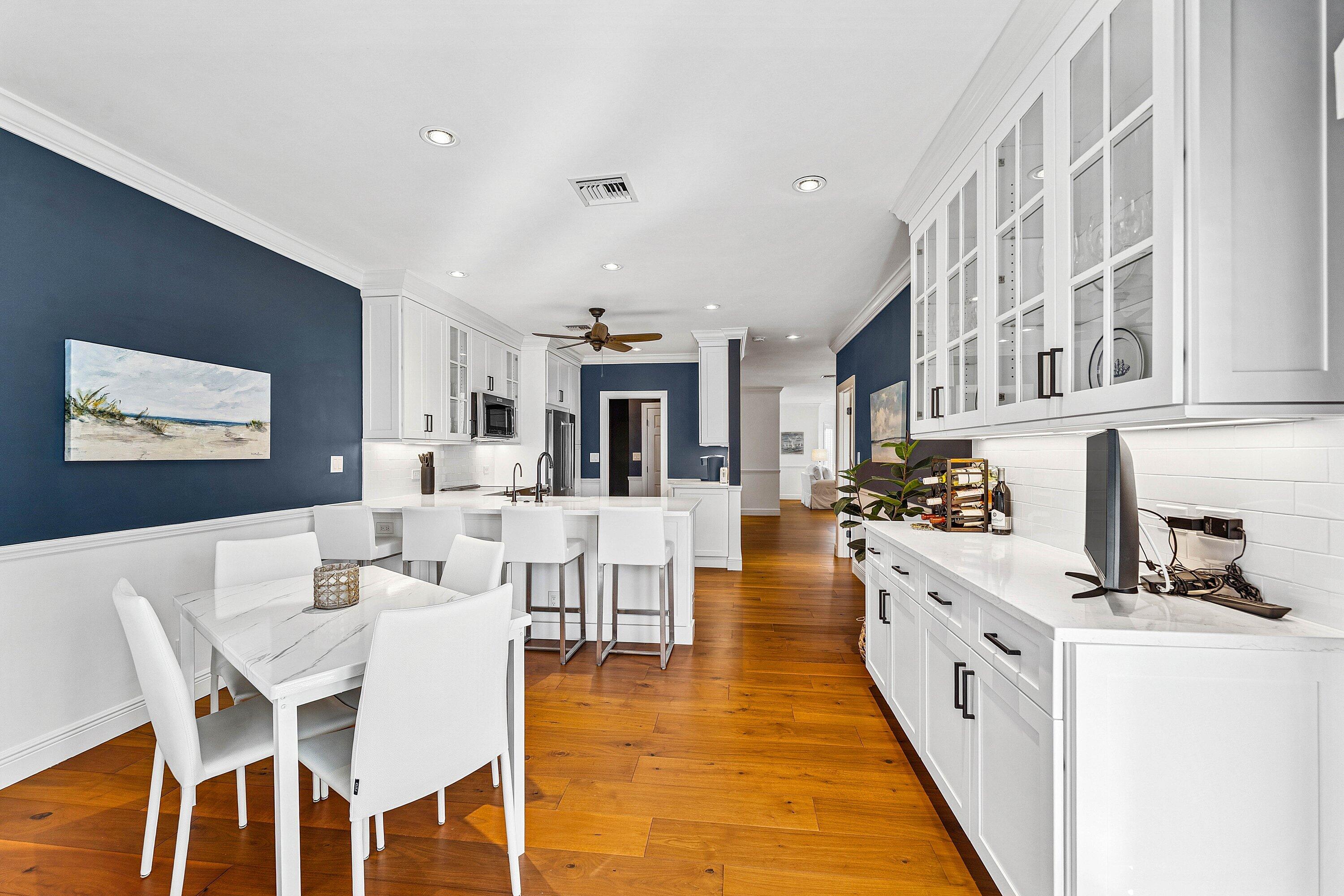 5900 Old Ocean Boulevard, Unit C4 Ocean Ridge, FL 33435 - Photo 9 of 25 a kitchen with stainless steel appliances kitchen island granite countertop a stove a sink a dining table and chairs