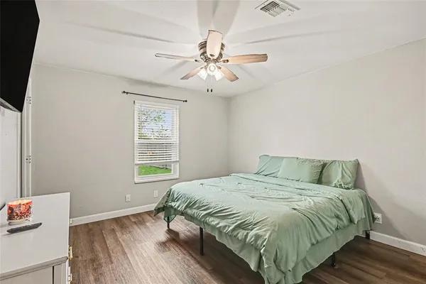 a bedroom with a bed and window
