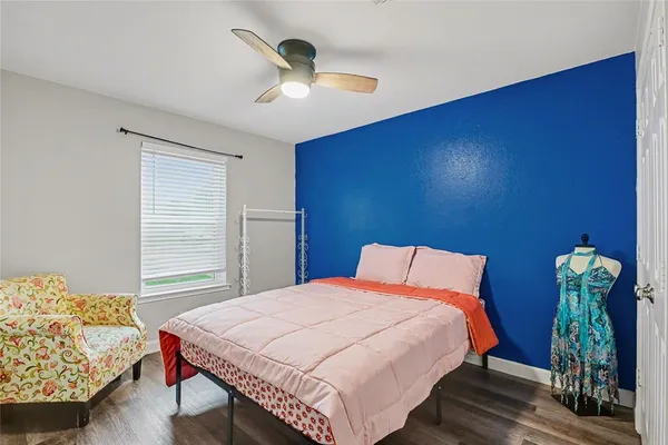 a bedroom with a bed table and a chandelier