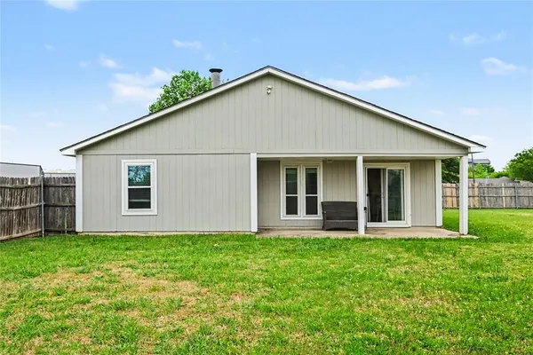 a front view of a house with yard and green space