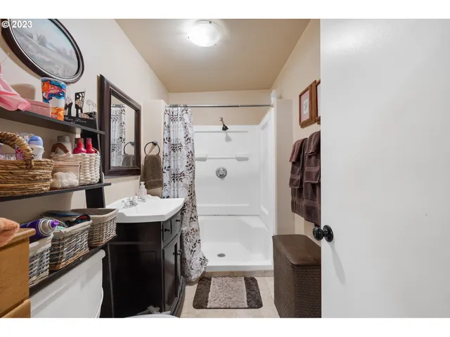 a utility room with fridge dryer and bicycles