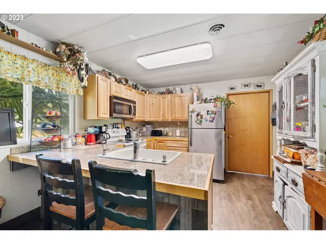 a living room with furniture a rug and a flat screen tv