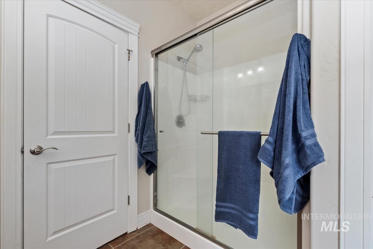 640 Southwest Miner Street Mountain Home, ID 83647 - Photo 23 of 35 Walk-in shower with a glass enclosure and a brushed nickel shower head