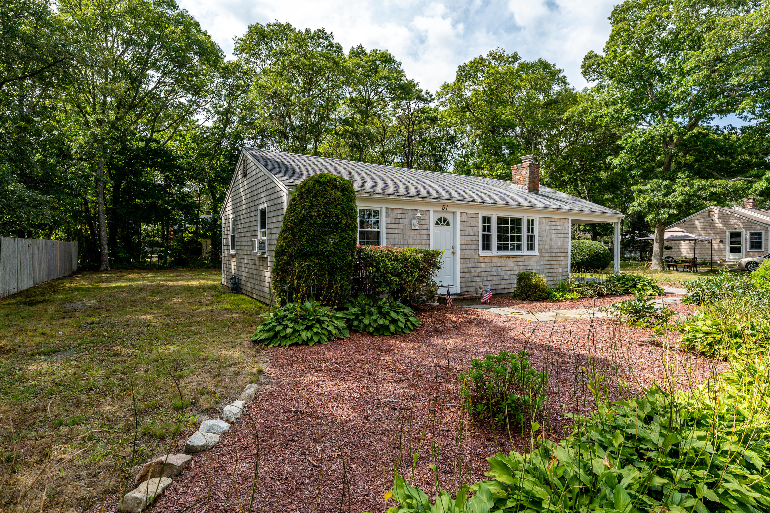 51 Pram Road Hyannis, MA 02601 - Photo 2 of 12 a view of a house with yard and a garden