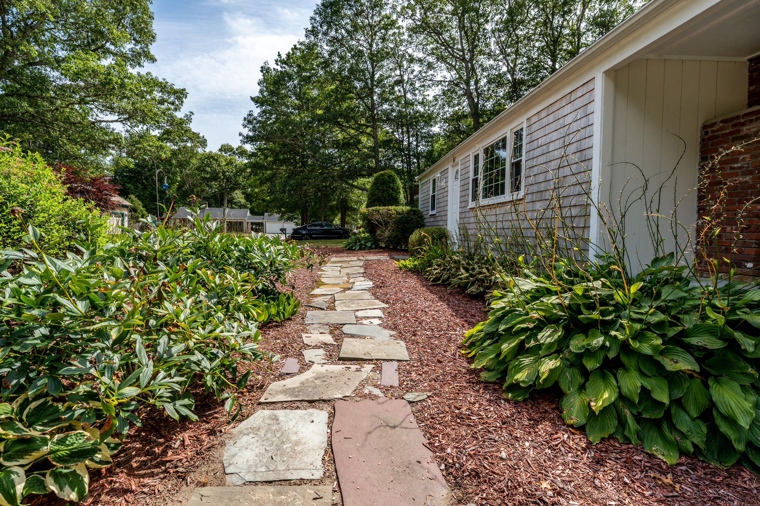 51 Pram Road Hyannis, MA 02601 - Photo 3 of 12 a backyard of a house with lots of green space
