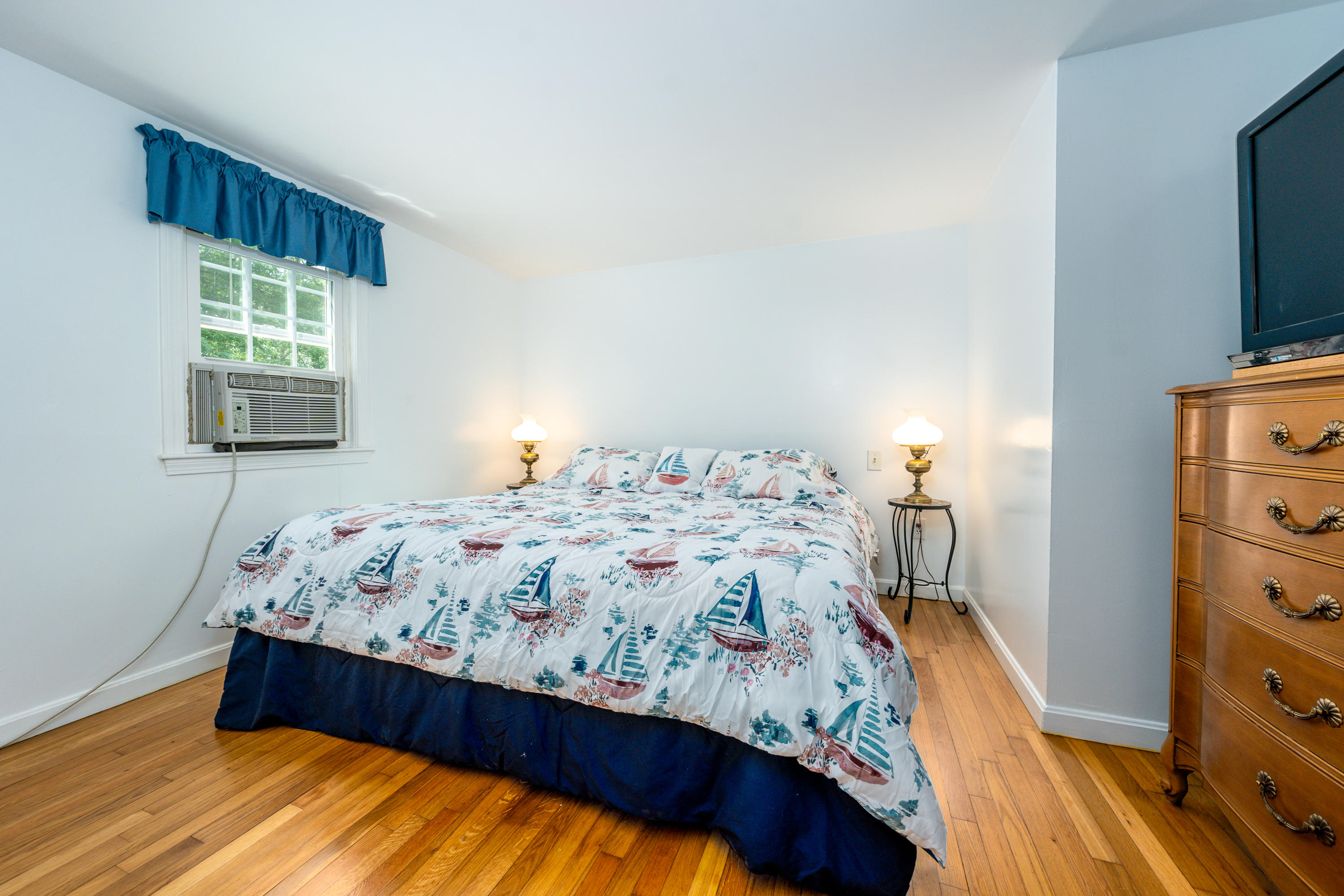 51 Pram Road Hyannis, MA 02601 - Photo 8 of 12 a bedroom with a bed and a flat tv screen on a dresser