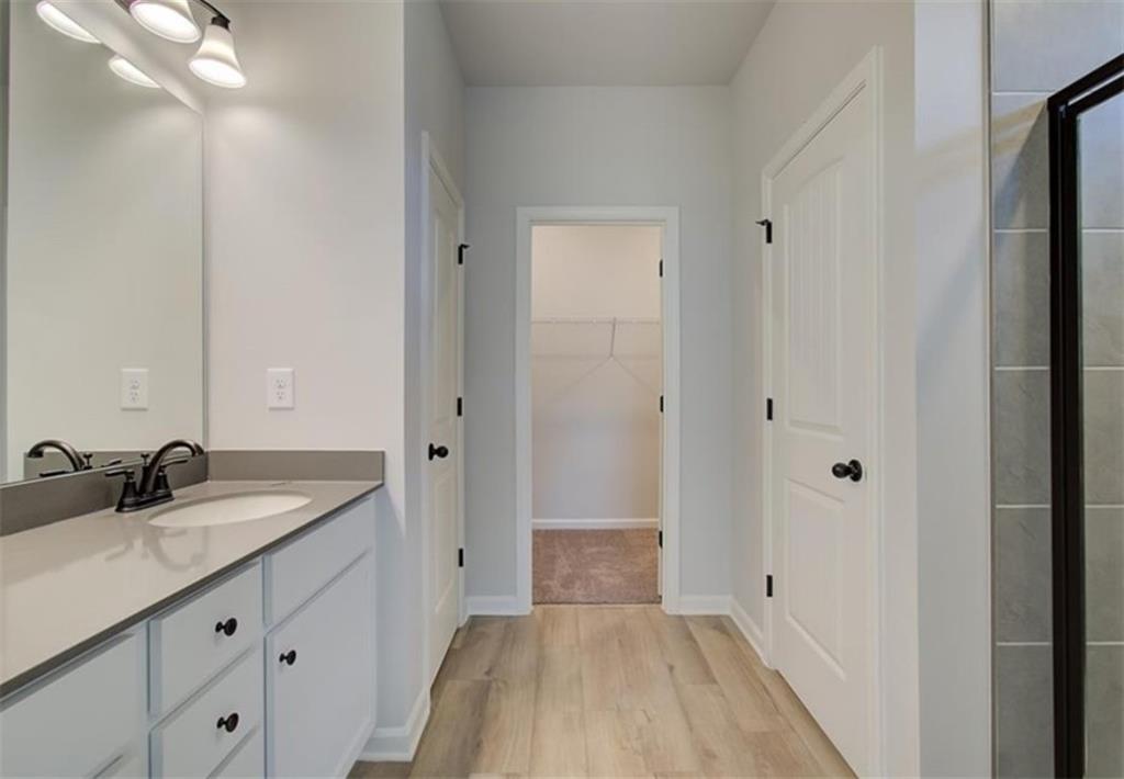 123 St Anne's Place Covington, GA 30016 - Photo 11 of 21 a bathroom with a sink a light fixture a vanity and a mirror