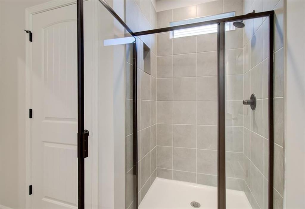 123 St Anne's Place Covington, GA 30016 - Photo 12 of 21 a bathroom with a glass shower door