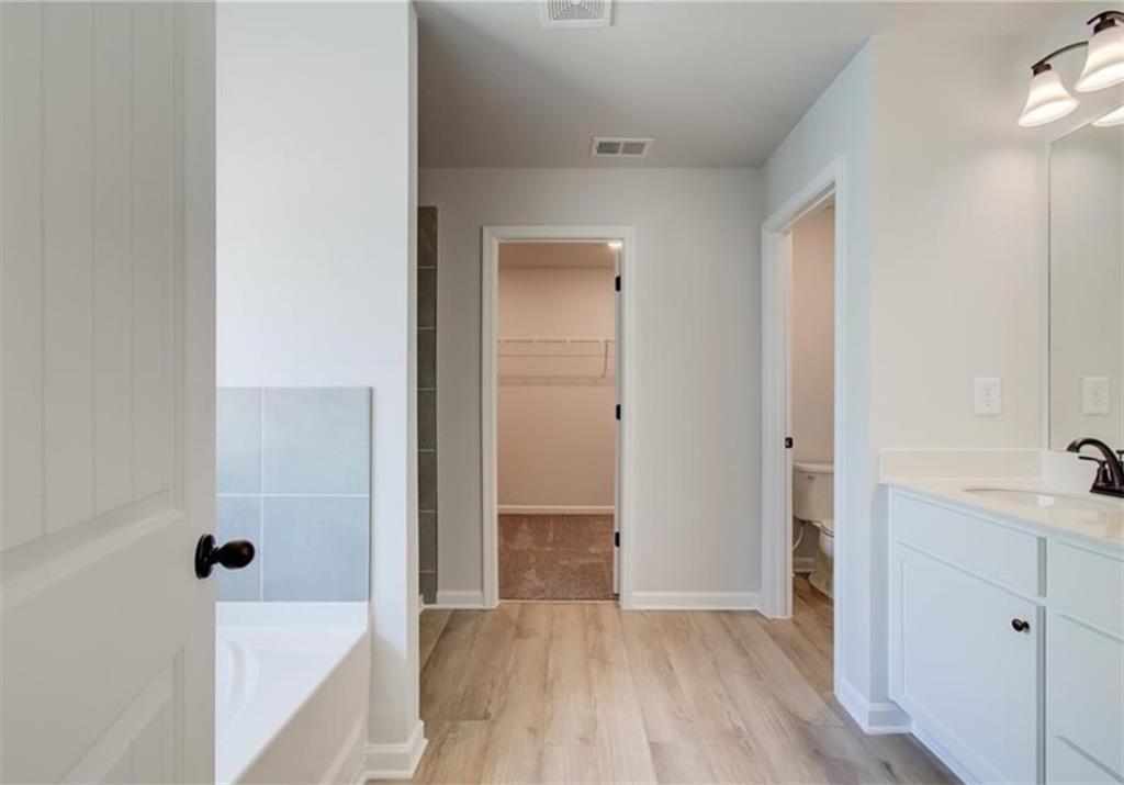 123 St Anne's Place Covington, GA 30016 - Photo 17 of 21 a view of a bathroom with a tub shower and sink