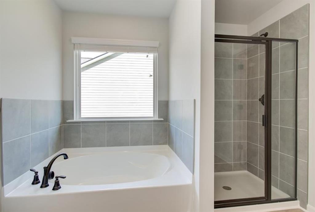 123 St Anne's Place Covington, GA 30016 - Photo 19 of 21 a white bath tub sitting next to a window
