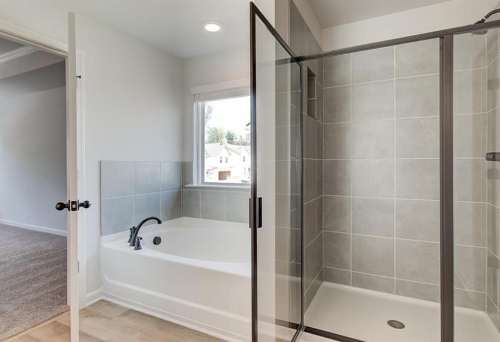 123 St Anne's Place Covington, GA 30016 - Photo 20 of 21 a bathroom with a bathtub and a shower