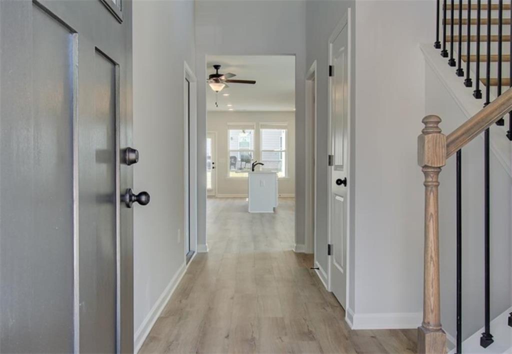 123 St Anne's Place Covington, GA 30016 - Photo 4 of 21 a view of a hallway with wooden floor and closet area