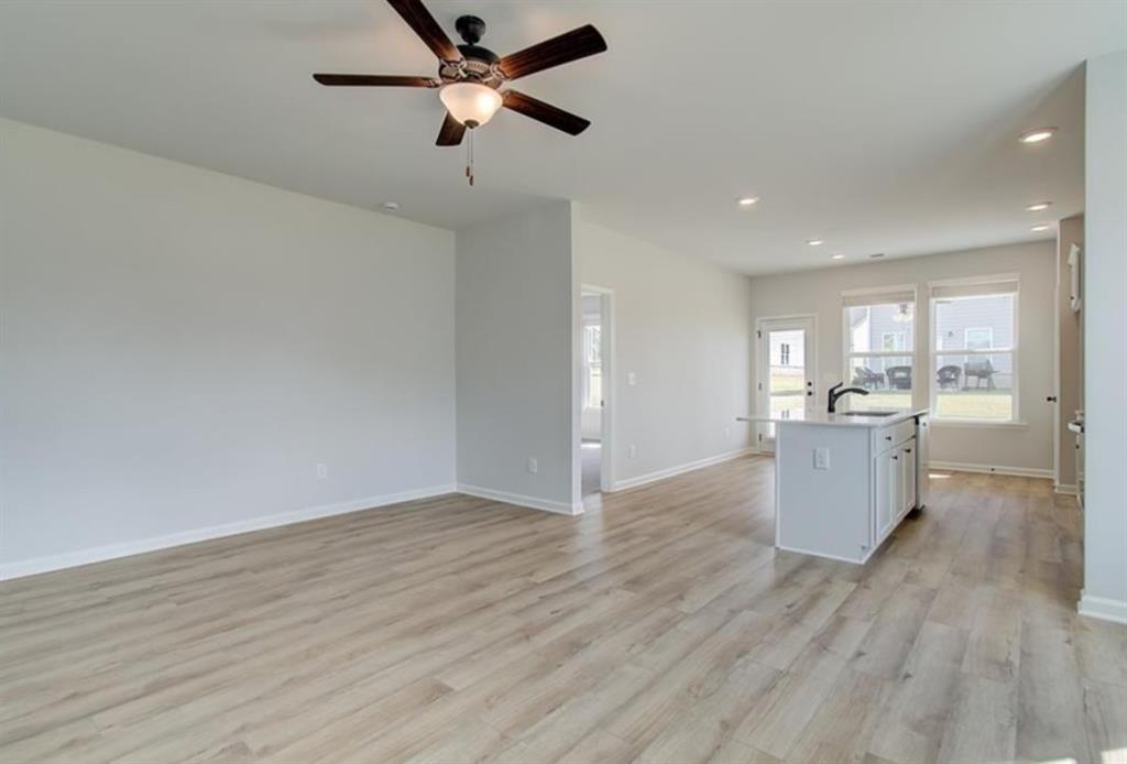 123 St Anne's Place Covington, GA 30016 - Photo 6 of 21 a view of a kitchen with furniture and wooden floor