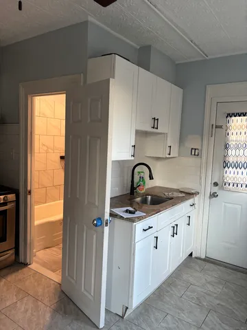 a kitchen with stainless steel appliances granite countertop a sink and a stove
