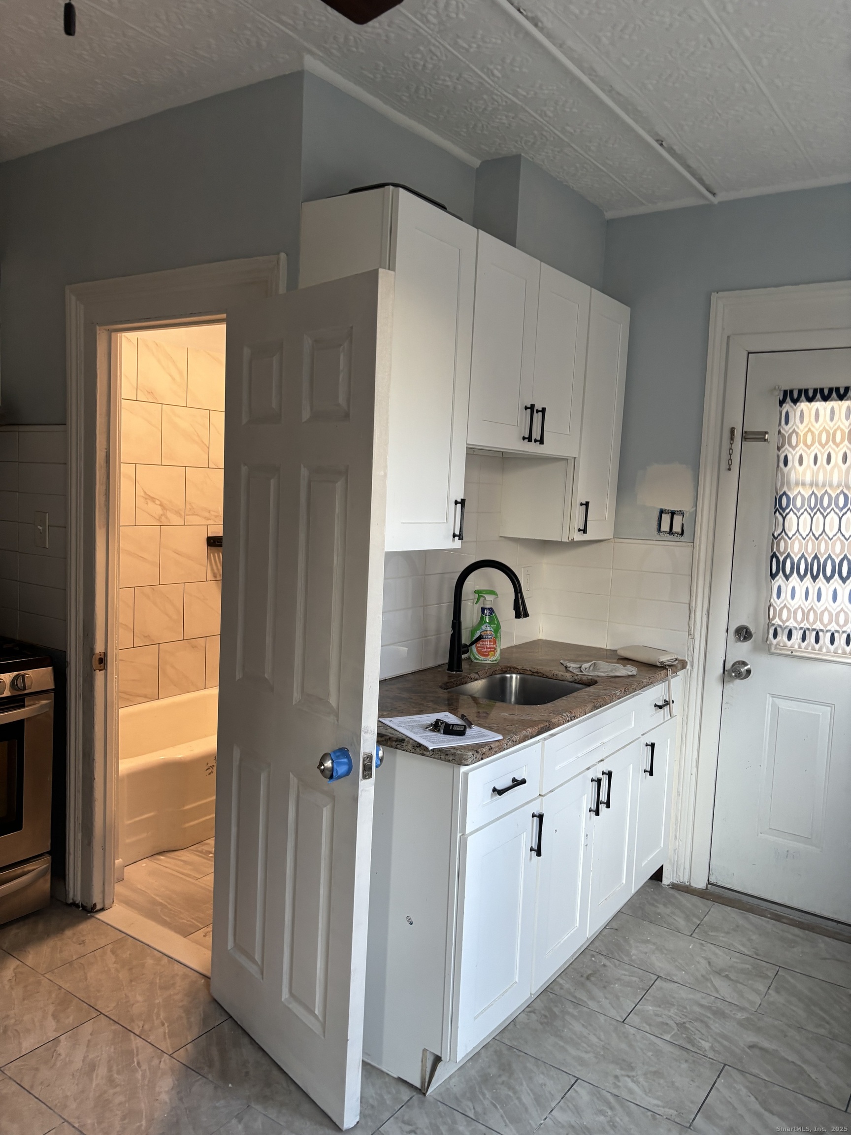 35 Washington Street Naugatuck, CT 06770 - Photo 3 of 16 a kitchen with stainless steel appliances granite countertop a sink and a stove