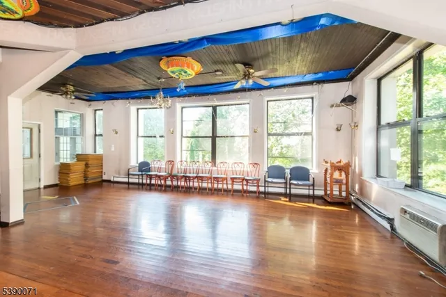 a view of a living room with hardwood floor and a large window