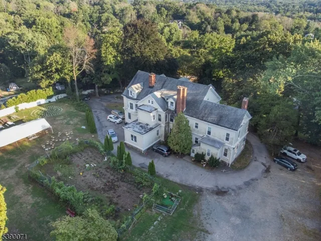 an aerial view of a house with a yard and lake view