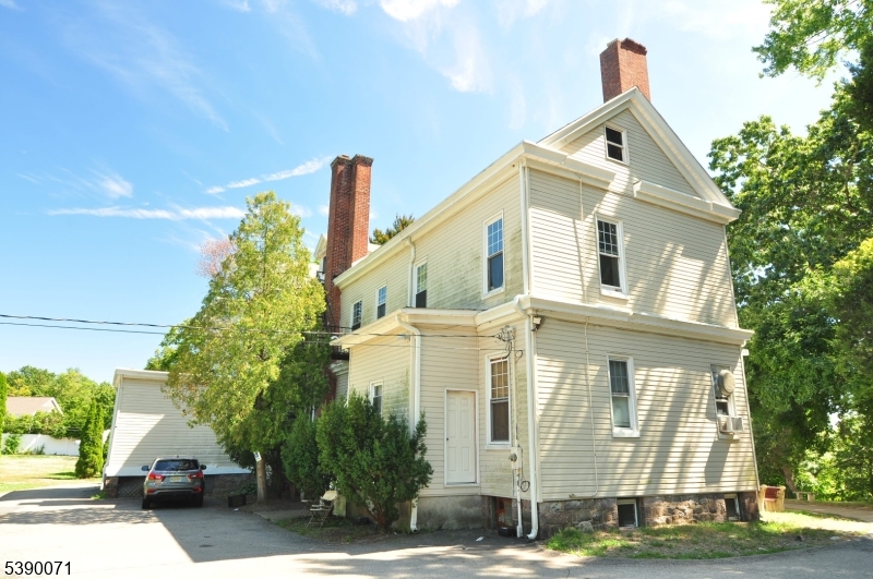 100 Jacksonville Road, Unit 10 Montville, NJ 07082 - Photo 5 of 18 a front view of a house with a yard and garage