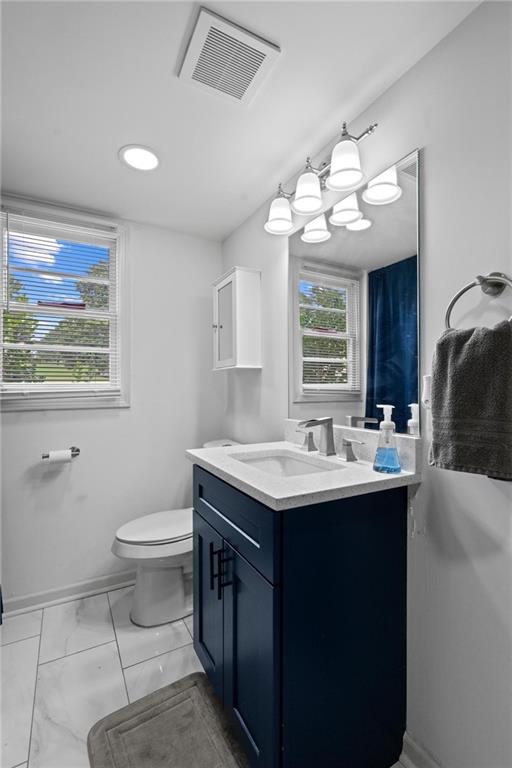 799 Pine Roc Drive Stone Mountain, GA 30083 - Photo 16 of 26 a view of a bathroom with a sink a toilet and a mirror