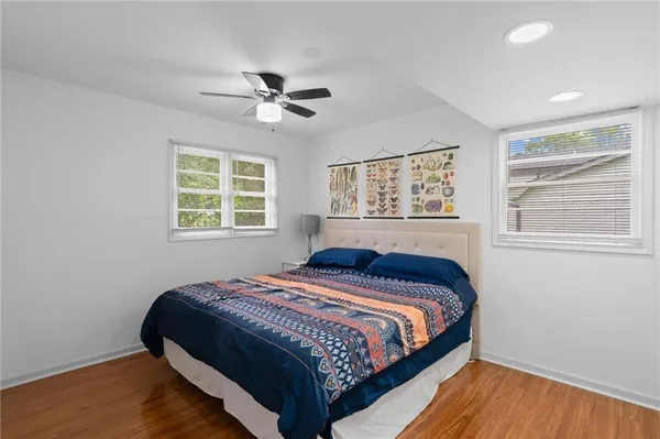 a bedroom with a bed and wooden floor