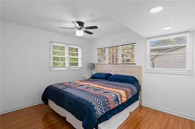 a bedroom with a bed and wooden floor