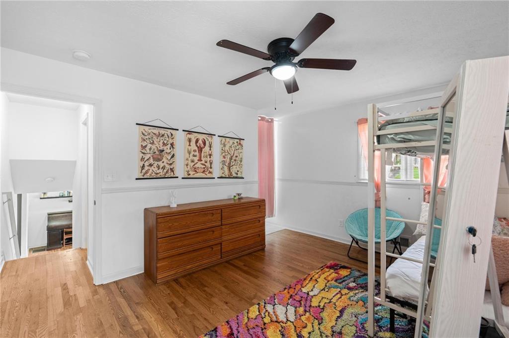 799 Pine Roc Drive Stone Mountain, GA 30083 - Photo 22 of 26 a living room with furniture and a chandelier