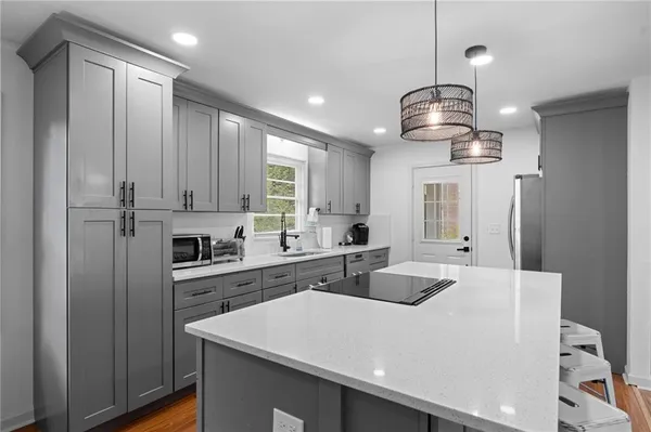 a kitchen with stainless steel appliances a center island and cabinets
