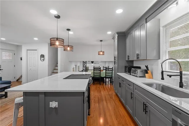 a kitchen with stainless steel appliances a sink stove and refrigerator
