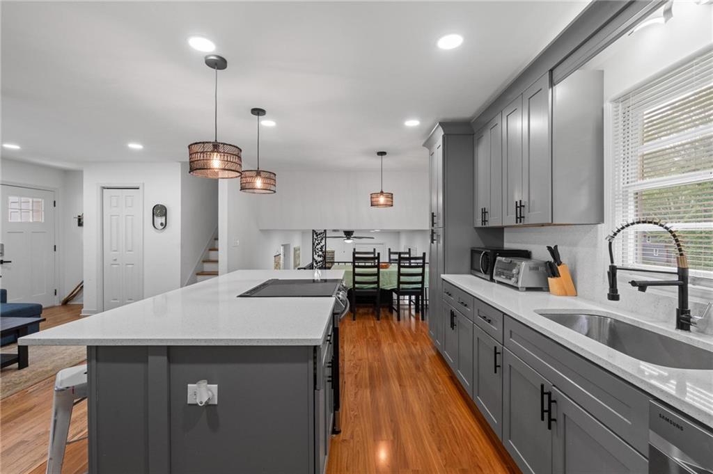 799 Pine Roc Drive Stone Mountain, GA 30083 - Photo 8 of 26 a kitchen with stainless steel appliances a sink stove and refrigerator