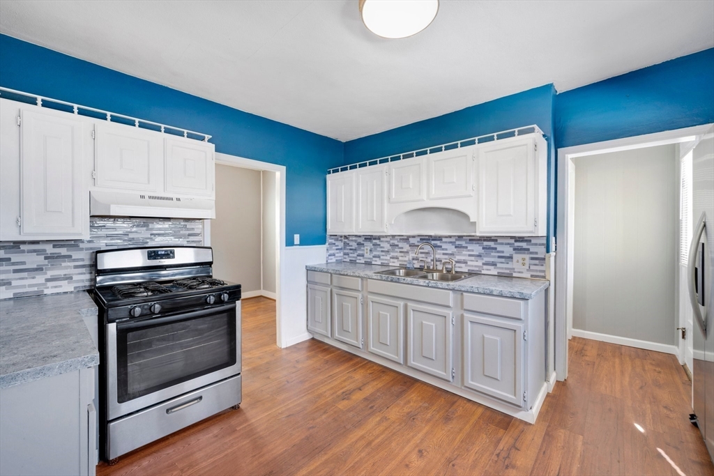 41 Briggs Street Springfield, MA 01151 - Photo 3 of 30 a kitchen with stainless steel appliances granite countertop a stove and a refrigerator