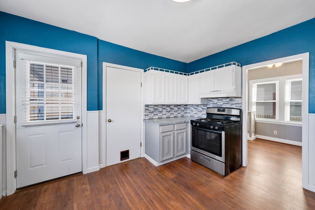 41 Briggs Street Springfield, MA 01151 - Photo 4 of 30 a kitchen with granite countertop a stove and a refrigerator