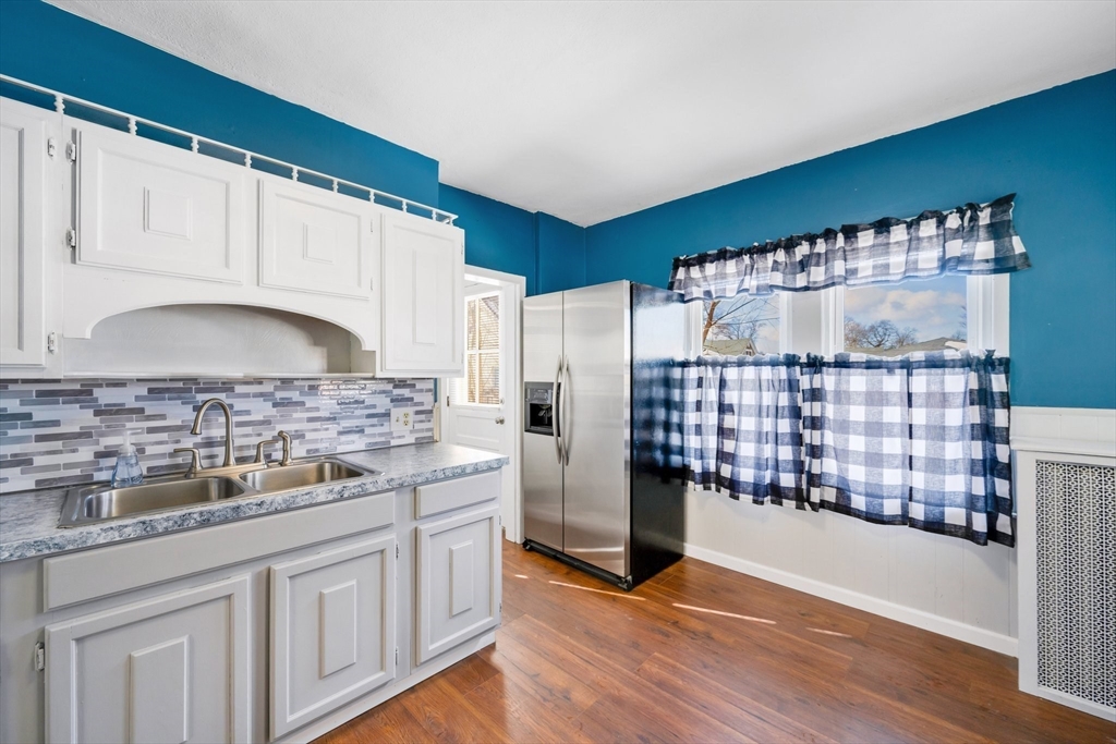 41 Briggs Street Springfield, MA 01151 - Photo 6 of 30 a kitchen with a wooden floor and cabinets