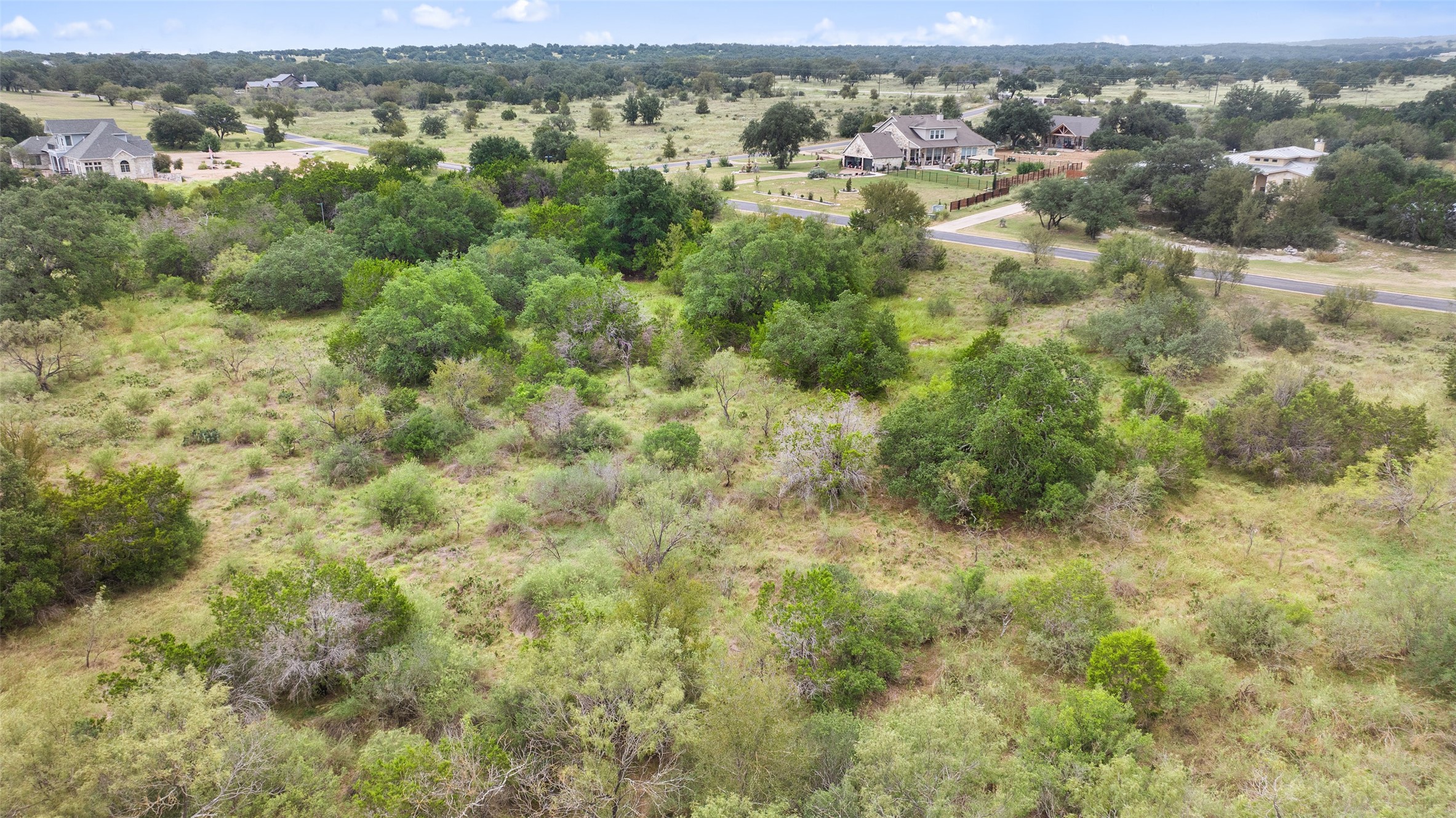 108 Cross Trail Spicewood, TX 78669 - Photo 6 of 33 an aerial view of residential houses with outdoor space and trees