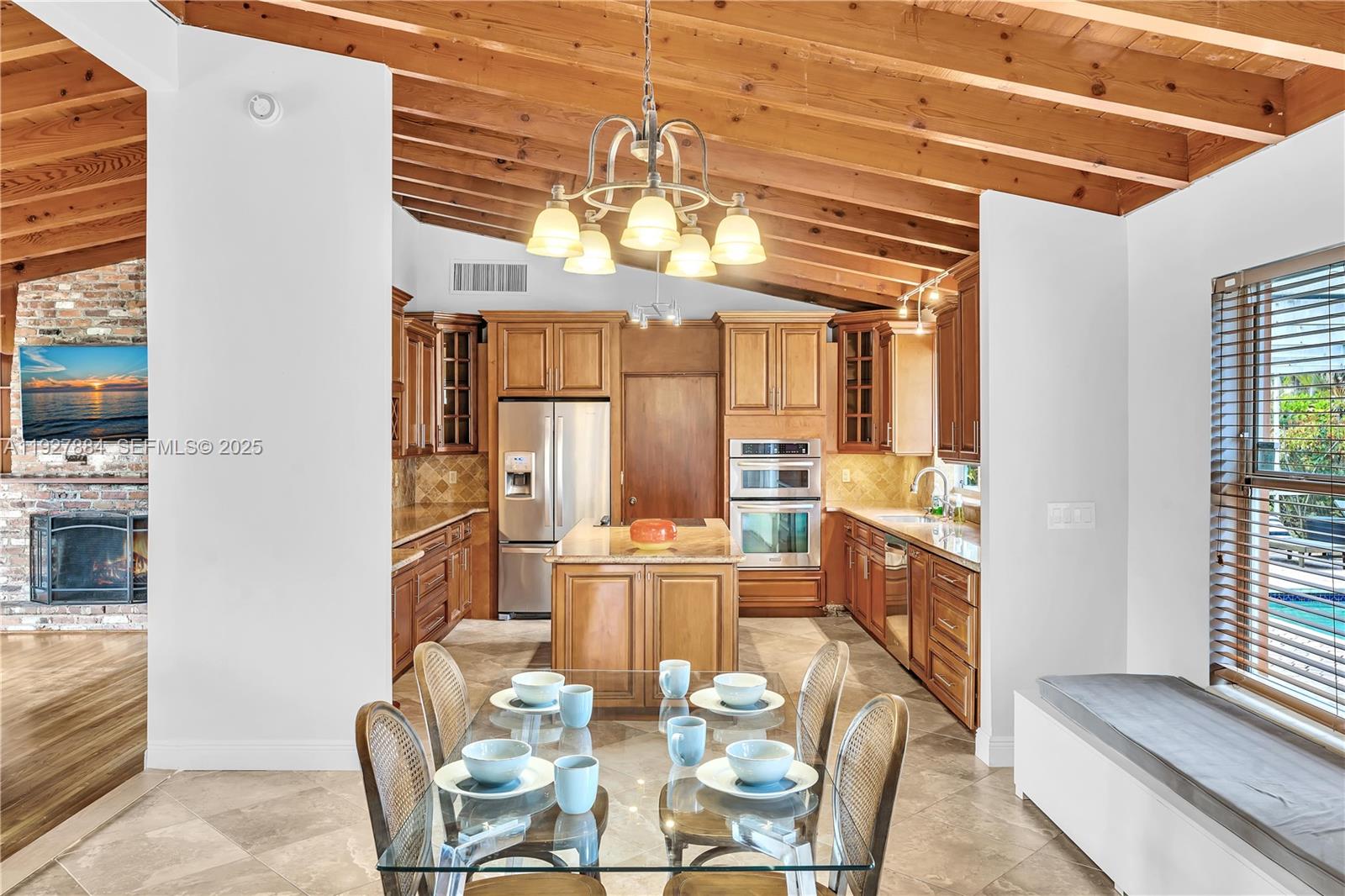 3437 Buchanan Street Hollywood, FL 33021 - Photo 11 of 40 a view of a dining room with furniture a chandelier and wooden floor