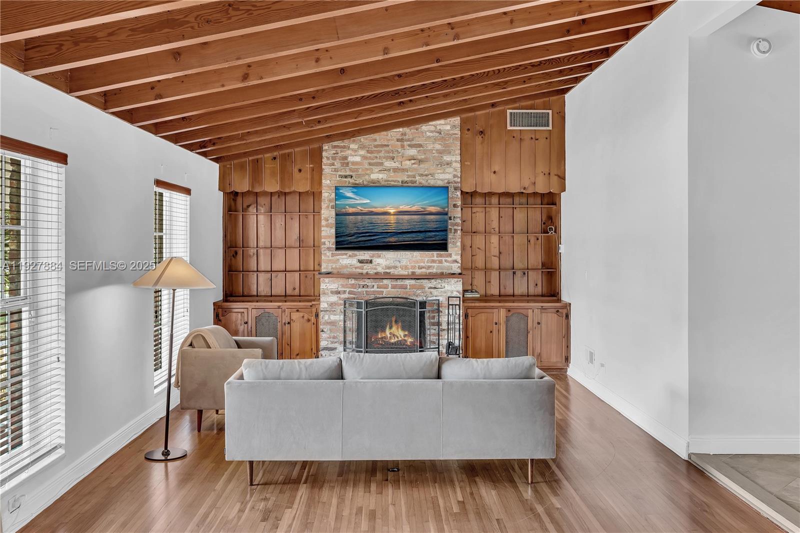 3437 Buchanan Street Hollywood, FL 33021 - Photo 12 of 40 a living room with furniture a fireplace and a flat screen tv